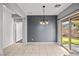 A dining area with tile flooring and a sliding glass door leading to the backyard at 6151 Moonlight Sonata Ave, Las Vegas, NV 89122