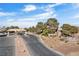 Inviting entrance to Stallion Mountain Golf Club with a stone gate and well-kept landscaping at 6151 Moonlight Sonata Ave, Las Vegas, NV 89122