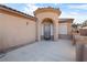 Single-story stucco home with tile roof and a decorative front entrance with sunscreens at 6151 Moonlight Sonata Ave, Las Vegas, NV 89122