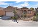 Inviting single-story home showcasing desert landscaping and a neutral color palette at 6151 Moonlight Sonata Ave, Las Vegas, NV 89122