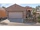 Charming single-story home showing desert landscaping and an attached two-car garage at 6151 Moonlight Sonata Ave, Las Vegas, NV 89122