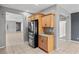 Modern kitchen with stainless steel refrigerator and view into the living spaces at 6151 Moonlight Sonata Ave, Las Vegas, NV 89122