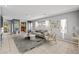 Bright living room featuring neutral furniture, tile flooring, and an open layout at 6151 Moonlight Sonata Ave, Las Vegas, NV 89122