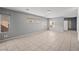 Spacious living room featuring tile flooring, light gray walls, and natural light at 6151 Moonlight Sonata Ave, Las Vegas, NV 89122