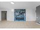 Bright living room featuring tile floors and an electric fireplace with dark blue decorative tile at 6151 Moonlight Sonata Ave, Las Vegas, NV 89122