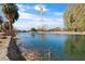 Picturesque pond with mature trees lining the bank and a serene, reflective surface at 6151 Moonlight Sonata Ave, Las Vegas, NV 89122