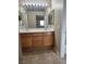 Double vanity bathroom with wood cabinets at 6460 Raven Hall St, North Las Vegas, NV 89084