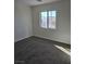 Bright bedroom with carpet and large window at 6460 Raven Hall St, North Las Vegas, NV 89084