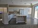 Modern kitchen featuring white cabinets, stainless steel appliances and island at 6460 Raven Hall St, North Las Vegas, NV 89084