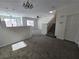 Open living and dining area with gray carpeting and neutral walls at 6460 Raven Hall St, North Las Vegas, NV 89084