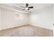 Bright, carpeted bedroom with modern ceiling fan and natural light at 659 D Ave, Boulder City, NV 89005