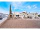 Charming single-story home featuring rock accents, a stone archway, and a gravel-covered yard at 659 D Ave, Boulder City, NV 89005