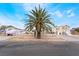 Charming single-story home with mature palm trees and rock accents, set against a clear blue sky at 659 D Ave, Boulder City, NV 89005