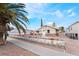 Charming single-story home featuring rock accents, a stone archway, a well-manicured yard, and mature palm trees at 659 D Ave, Boulder City, NV 89005