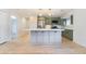 Modern kitchen featuring stainless steel appliances, gray cabinets, a center island, and light wood flooring at 659 D Ave, Boulder City, NV 89005