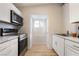 Galley-style kitchen features stainless steel appliances, white cabinets, and white marble countertops at 659 D Ave, Boulder City, NV 89005