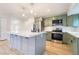 Modern kitchen featuring stainless steel appliances, gray cabinets, a center island, and light wood flooring at 659 D Ave, Boulder City, NV 89005