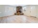 Bright living room featuring a stone fireplace, light wood floors, and large windows for natural light at 659 D Ave, Boulder City, NV 89005