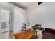 This is a view into the living room with wood-look floors, neutral walls, and a partial view of the bathroom at 659 D Ave, Boulder City, NV 89005