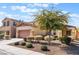 Two-story house with a two-car garage and mature tree in front at 6713 Chambers Lake Ct, North Las Vegas, NV 89084