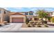 Two-story house with a two-car garage and nicely landscaped front yard at 6713 Chambers Lake Ct, North Las Vegas, NV 89084