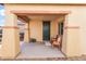 Covered front porch with seating for two and a dark green door at 6713 Chambers Lake Ct, North Las Vegas, NV 89084