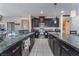 Modern kitchen featuring dark cabinetry, granite countertops, and stainless steel appliances at 6713 Chambers Lake Ct, North Las Vegas, NV 89084