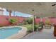 Backyard oasis with a kidney-shaped pool and covered patio at 7200 Big Rock Cir, Las Vegas, NV 89129