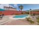 Inviting kidney-shaped pool with brick patio and seating area at 7200 Big Rock Cir, Las Vegas, NV 89129