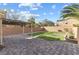 The backyard features an outdoor living space with grass and stone pavers at 7516 Evening Melody Ct, Las Vegas, NV 89178