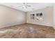 Large bedroom with tile flooring, ceiling fan, and natural light from shuttered windows at 7516 Evening Melody Ct, Las Vegas, NV 89178