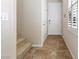 Welcoming entryway with tile flooring, white door, and staircase leading to upper level at 7516 Evening Melody Ct, Las Vegas, NV 89178