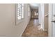 Bright hallway with tile flooring, white trim, and natural light from plantation shutters at 7516 Evening Melody Ct, Las Vegas, NV 89178