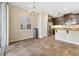 Bright, tiled kitchen with stainless steel appliances and a granite countertop at 7516 Evening Melody Ct, Las Vegas, NV 89178