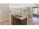 Granite countertop island bar in a bright kitchen with outdoor access and windows at 7516 Evening Melody Ct, Las Vegas, NV 89178