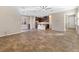 Bright and open living area with tile floors, ceiling fan, and an adjacent kitchen at 7516 Evening Melody Ct, Las Vegas, NV 89178