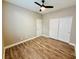 Spacious bedroom with wood floors, ceiling fan, and double door closet at 773 Valley Rise Dr, Henderson, NV 89052