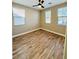 Bright bedroom with wood-look floors, ceiling fan, and large windows at 773 Valley Rise Dr, Henderson, NV 89052