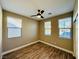 Sunny bedroom with wood floors, ceiling fan and two windows at 773 Valley Rise Dr, Henderson, NV 89052