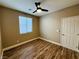 Well-lit bedroom with wood floors, window, and ceiling fan at 773 Valley Rise Dr, Henderson, NV 89052