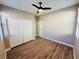 Spacious bedroom with wood floors, ceiling fan and double door closet at 773 Valley Rise Dr, Henderson, NV 89052