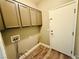 Laundry room with upper cabinets and door to outside at 773 Valley Rise Dr, Henderson, NV 89052