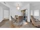 Cozy dining area with a modern chandelier, seating for four, and sliding glass doors leading to a balcony at 8250 N Grand Canyon Dr # 1040, Las Vegas, NV 89166