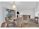 A dining area leading to a large living room with neutral toned decor at 8250 N Grand Canyon Dr # 1040, Las Vegas, NV 89166