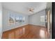 Bright bedroom with large windows offering neighborhood views and wood-look flooring at 8389 Charlton Valley Ct, Las Vegas, NV 89123