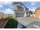 Home exterior with a well-manicured lawn and a two-car garage at 8389 Charlton Valley Ct, Las Vegas, NV 89123