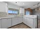 Modern kitchen with white cabinets, stainless steel appliances, and updated countertops at 8389 Charlton Valley Ct, Las Vegas, NV 89123