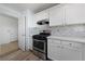 Clean kitchen features white cabinets, stainless steel appliances, and updated countertops at 8389 Charlton Valley Ct, Las Vegas, NV 89123