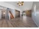 Open living room with beautiful wood floors, a staircase, a wood accent wall and modern lighting fixtures at 8389 Charlton Valley Ct, Las Vegas, NV 89123