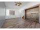 Inviting living room with wood-look floors, vaulted ceilings, and a view of the staircase at 8389 Charlton Valley Ct, Las Vegas, NV 89123